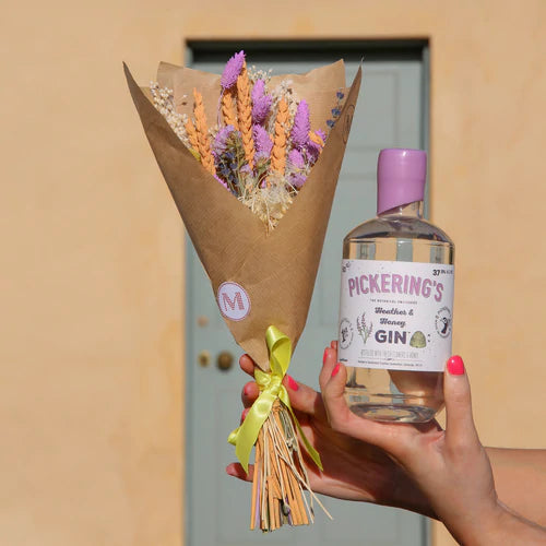 Bottle of Pickering's Heather & Honey Gin with a bouquet of flowers 