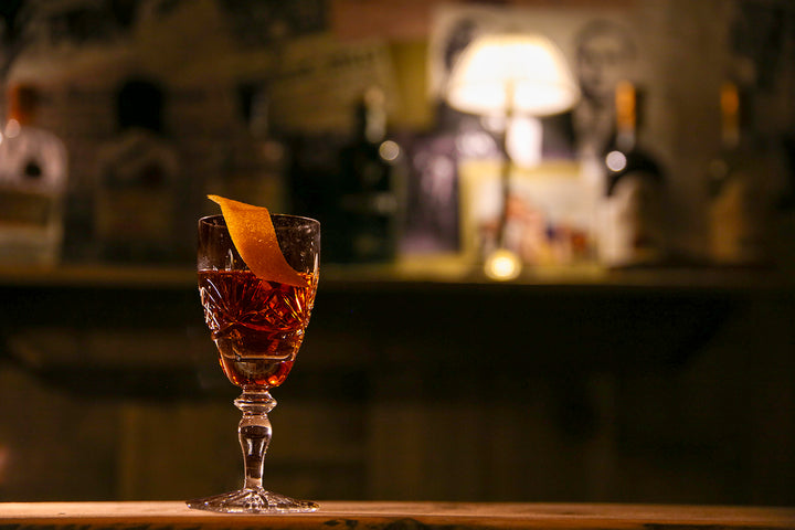 Cocktail on a table in a dimly lit bar