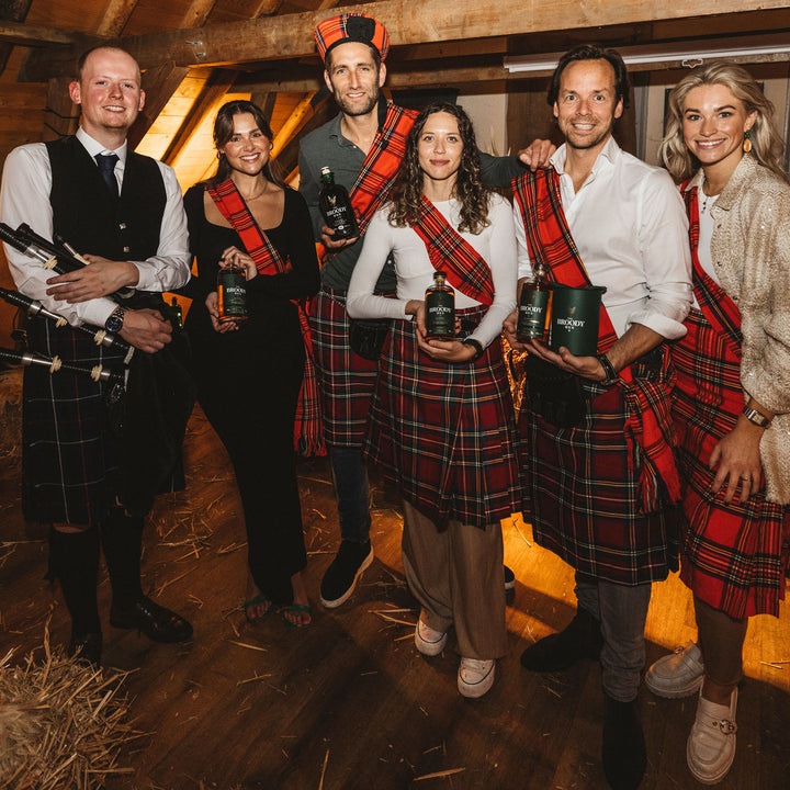 Group of people wearing tartan and kilts