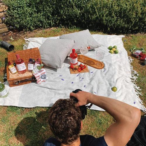 Someone taking a photograph of a picnic setting