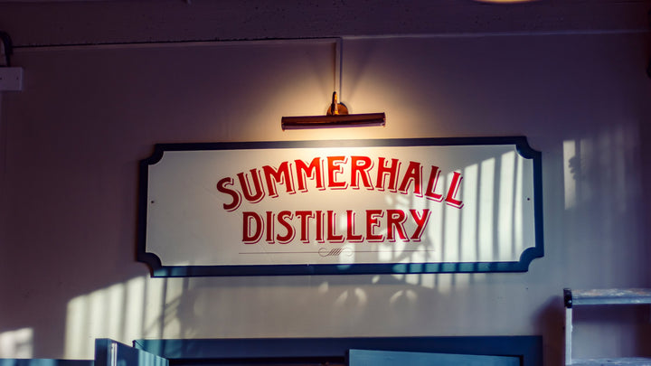 6 People cheersing drinks outside of Summerhall Distillery