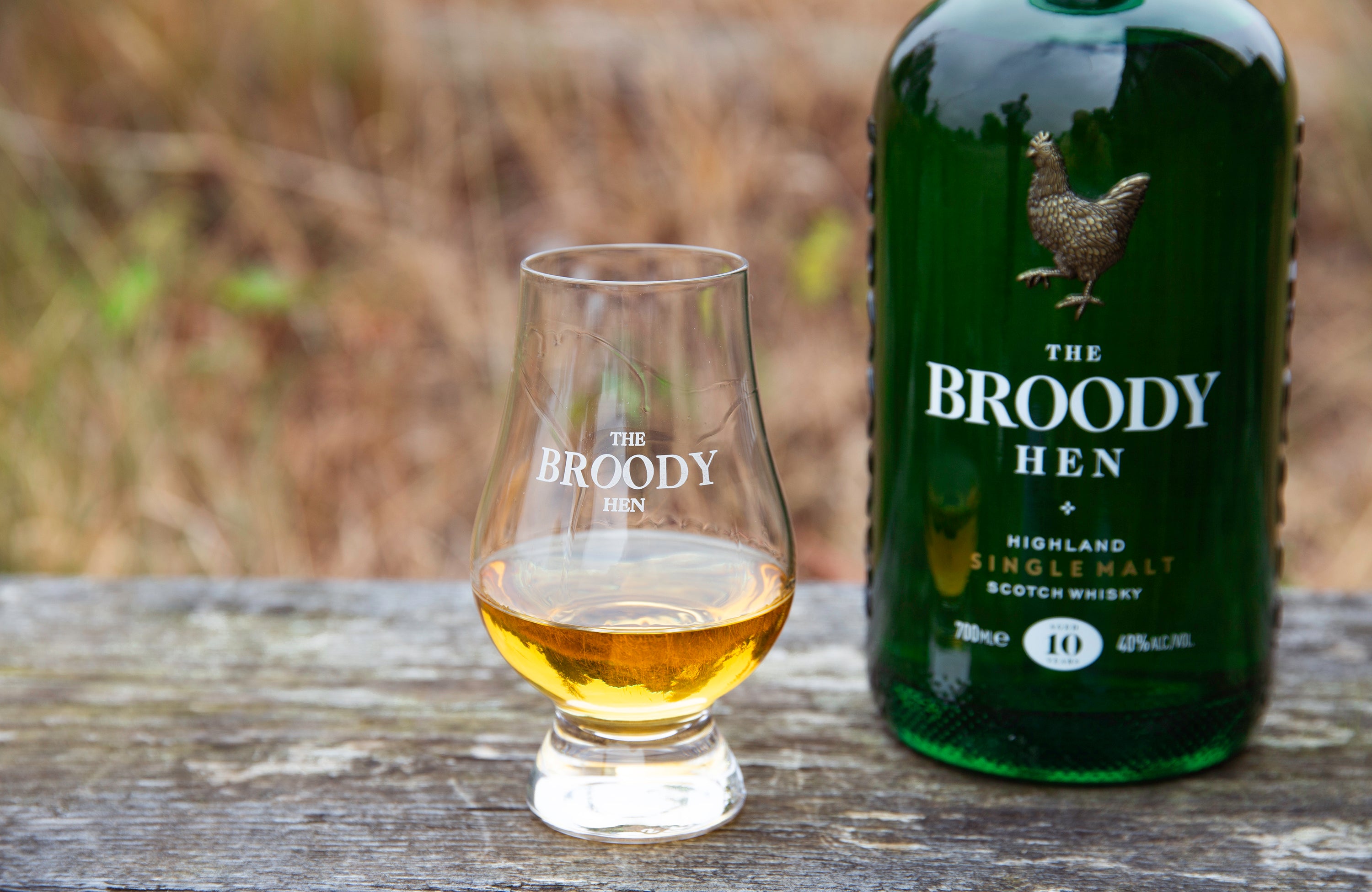 Dram of whisky on a wooden plank