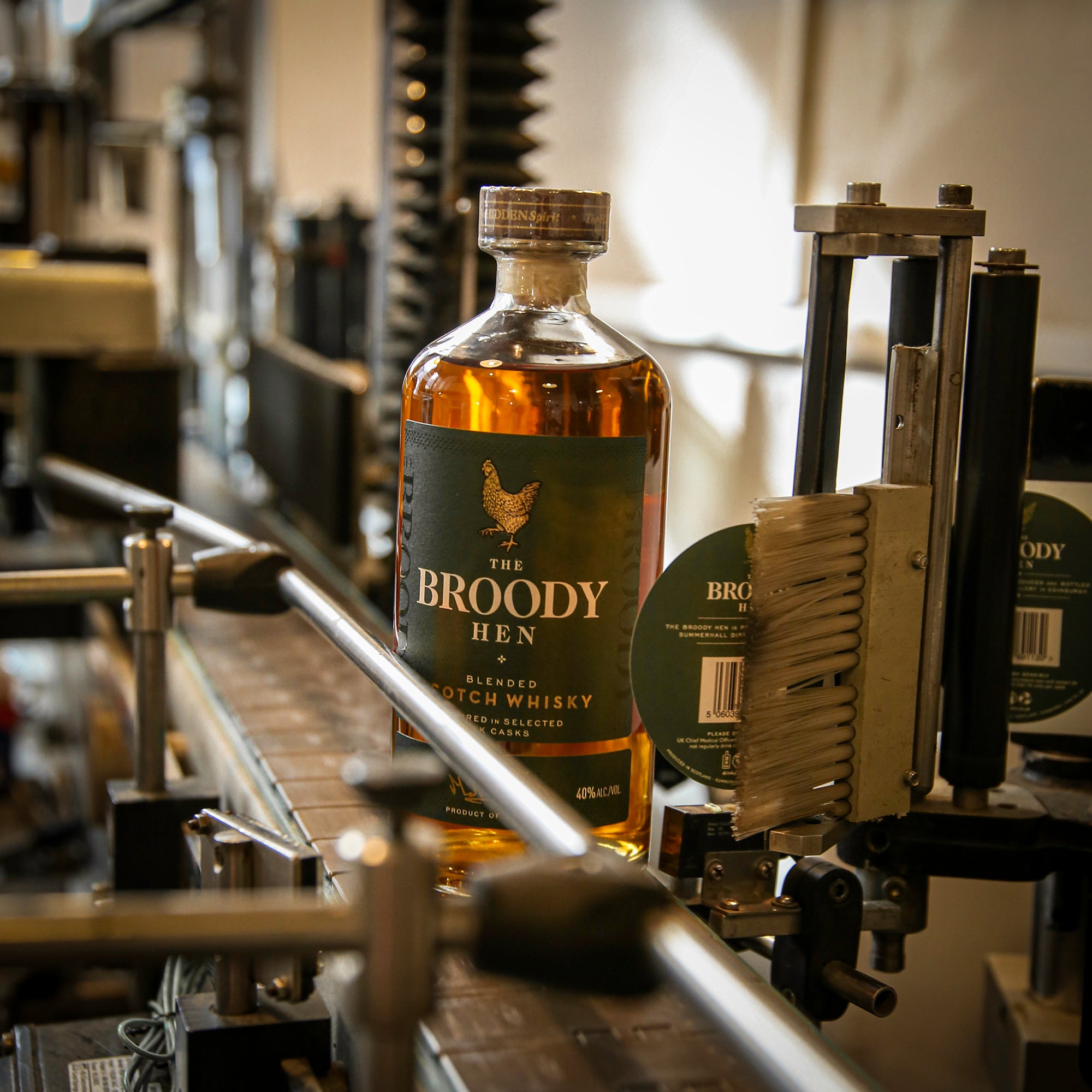 Bottle of The Broody Hen Blended Scotch Whisky on the bottling line