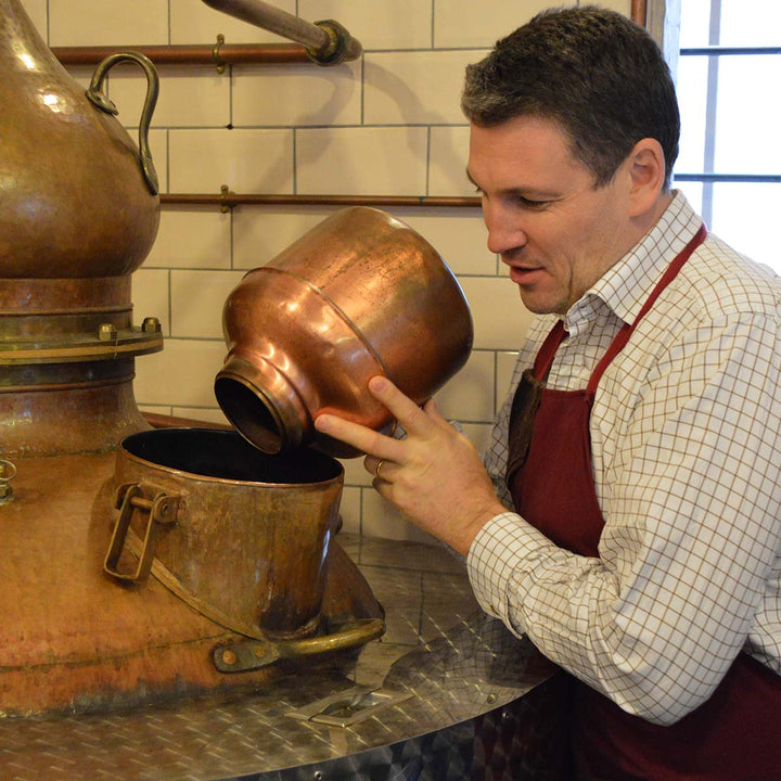 Matt pouring botanicals into still