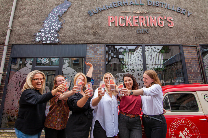 Group of women cheersing outside Summerhall Distillery