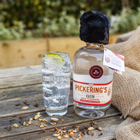 Pickering's Navy Strength Gin on a table next to a Gin & Tonic