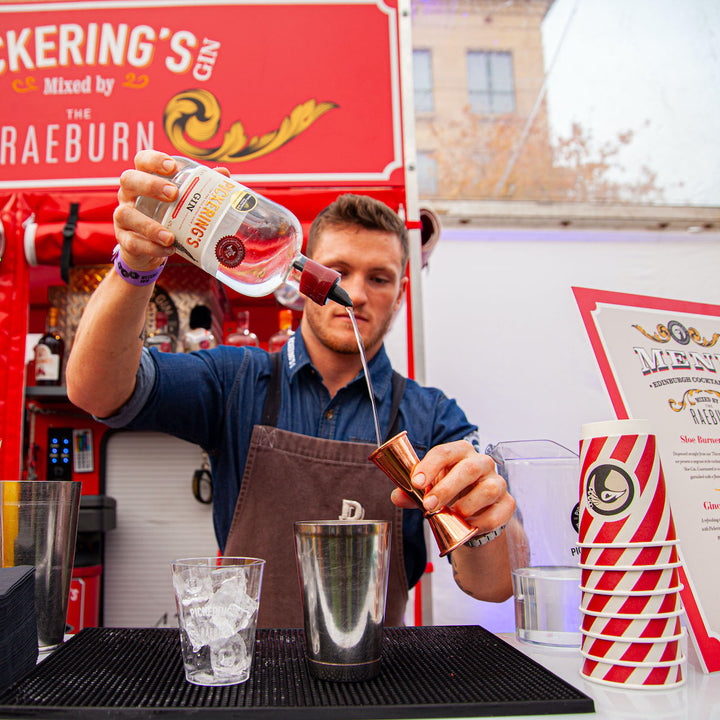 Someone pouring Pickering's Gin into a shaker