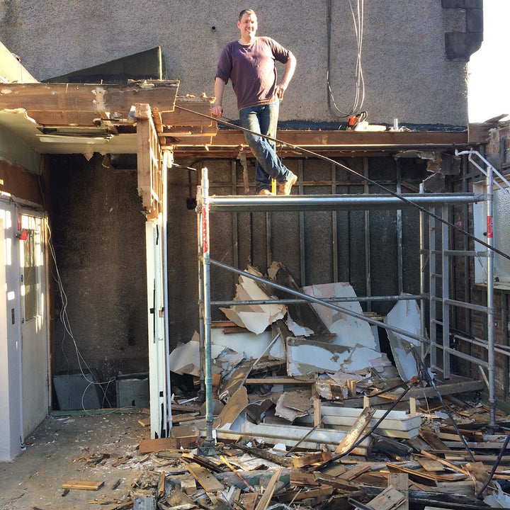 Matt standing on scaffolding building the office upstairs