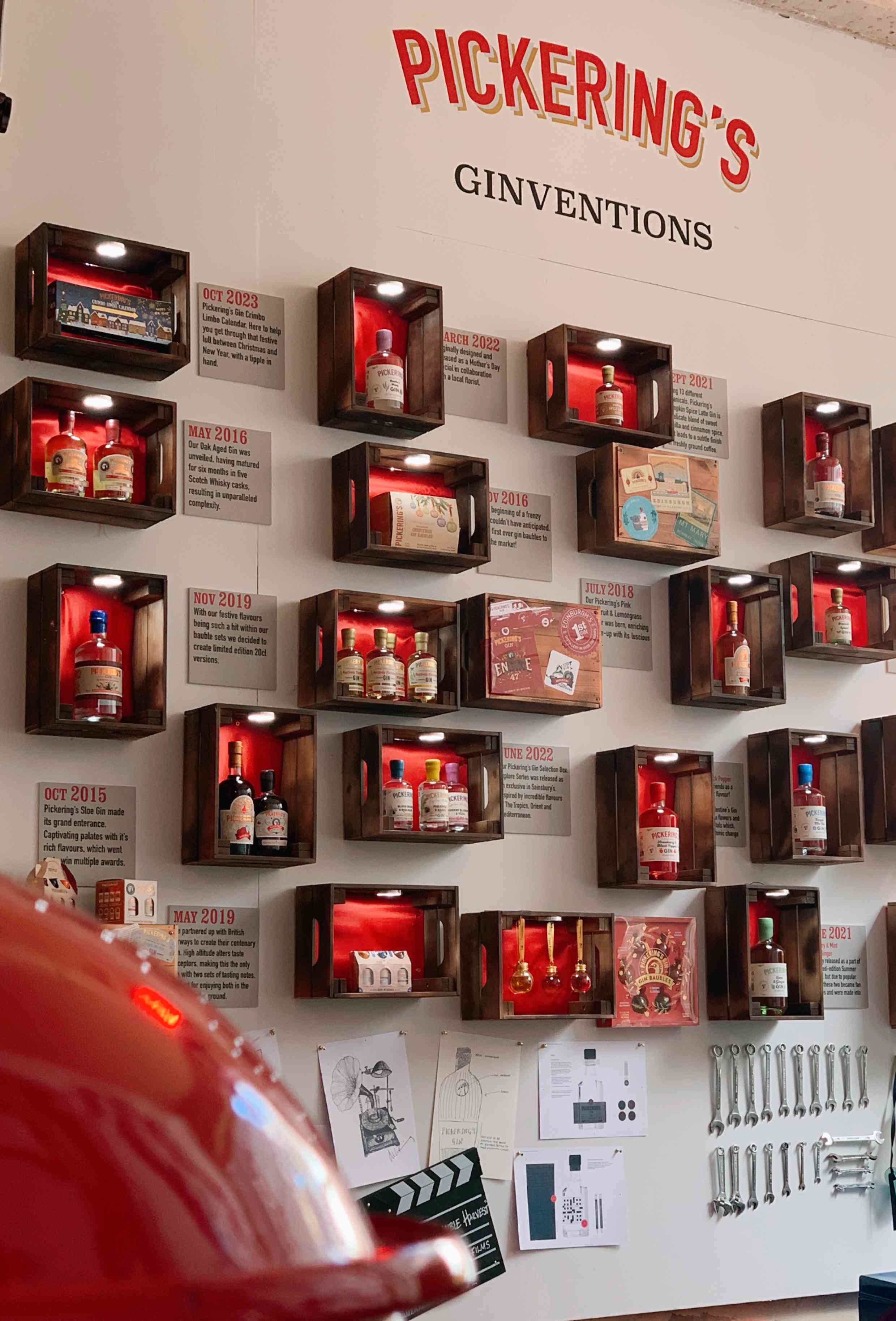 Wall display of Pickering's Ginventions with illuminated shelves and product labels.