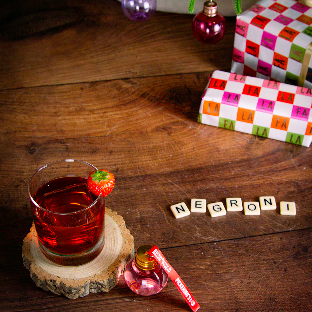 Strawberry & Black Pepper Negroni with presents in the background