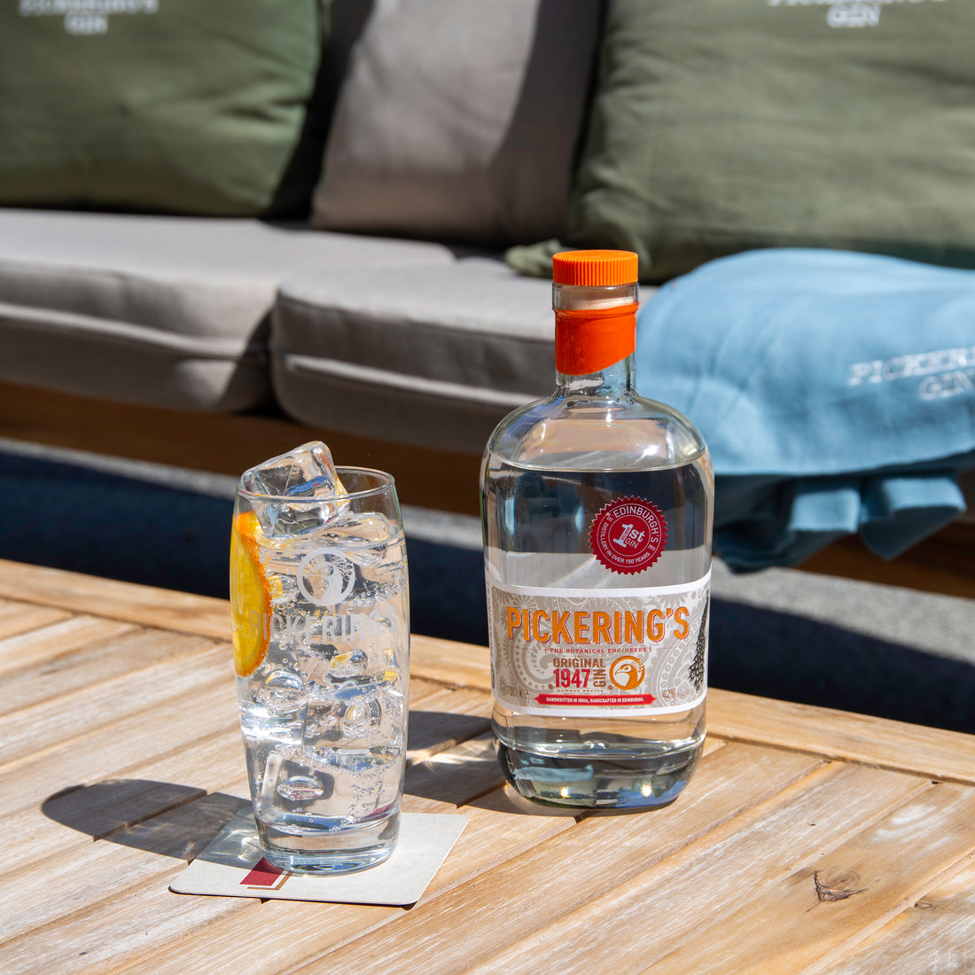 Bottle of Pickering Original 1947 Gin on a table with a gin and tonic