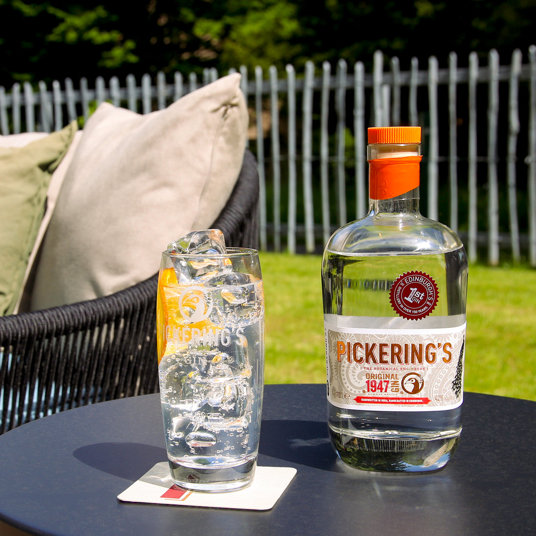 Bottle of Pickering Original 1947 Gin on a table with a gin and tonic