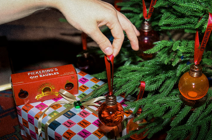 Pickering's Gin Bauble next to a tree