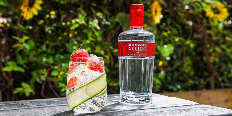 Bottle of Queen Mary 2 Cunard Gin next to a G&amp;T