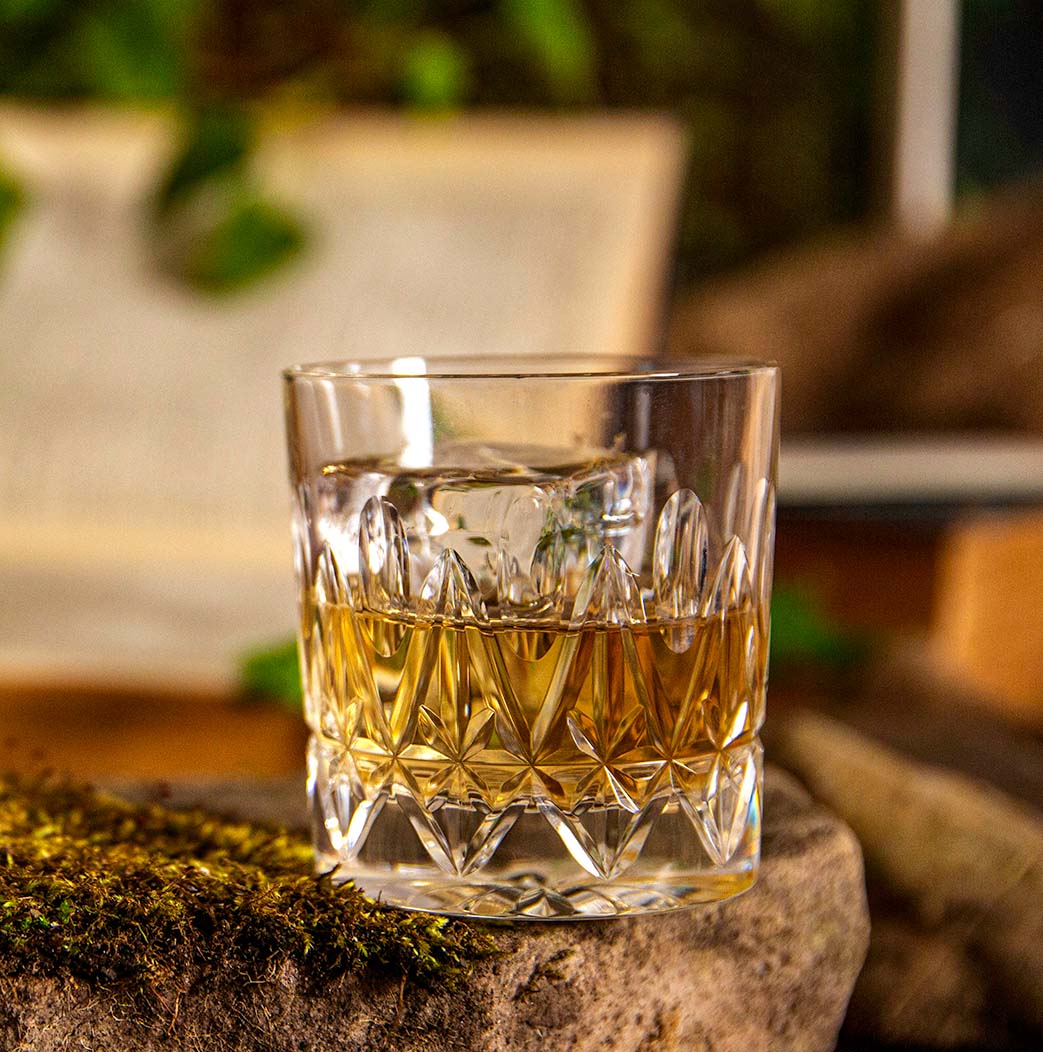 Dram of The Broody Hen Whisky on a rock